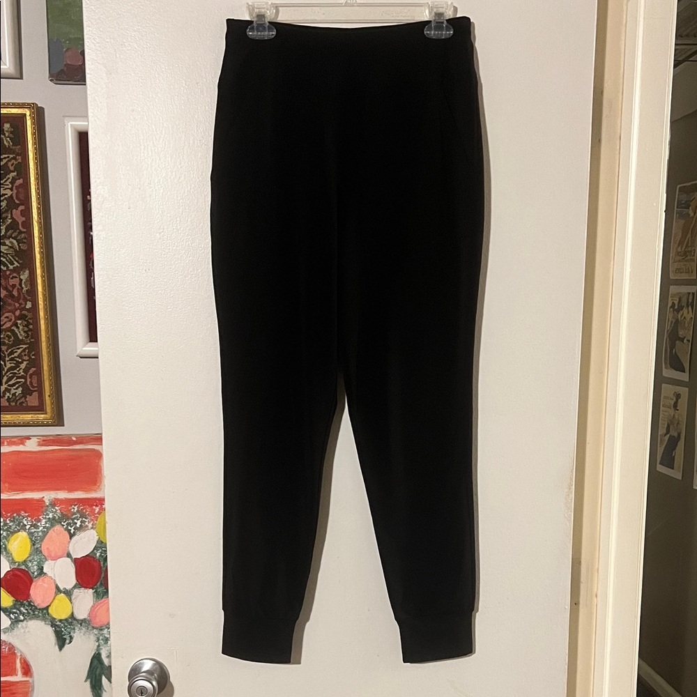 Sympli black jersey pants. Elastic waist and ankle front slash pockets